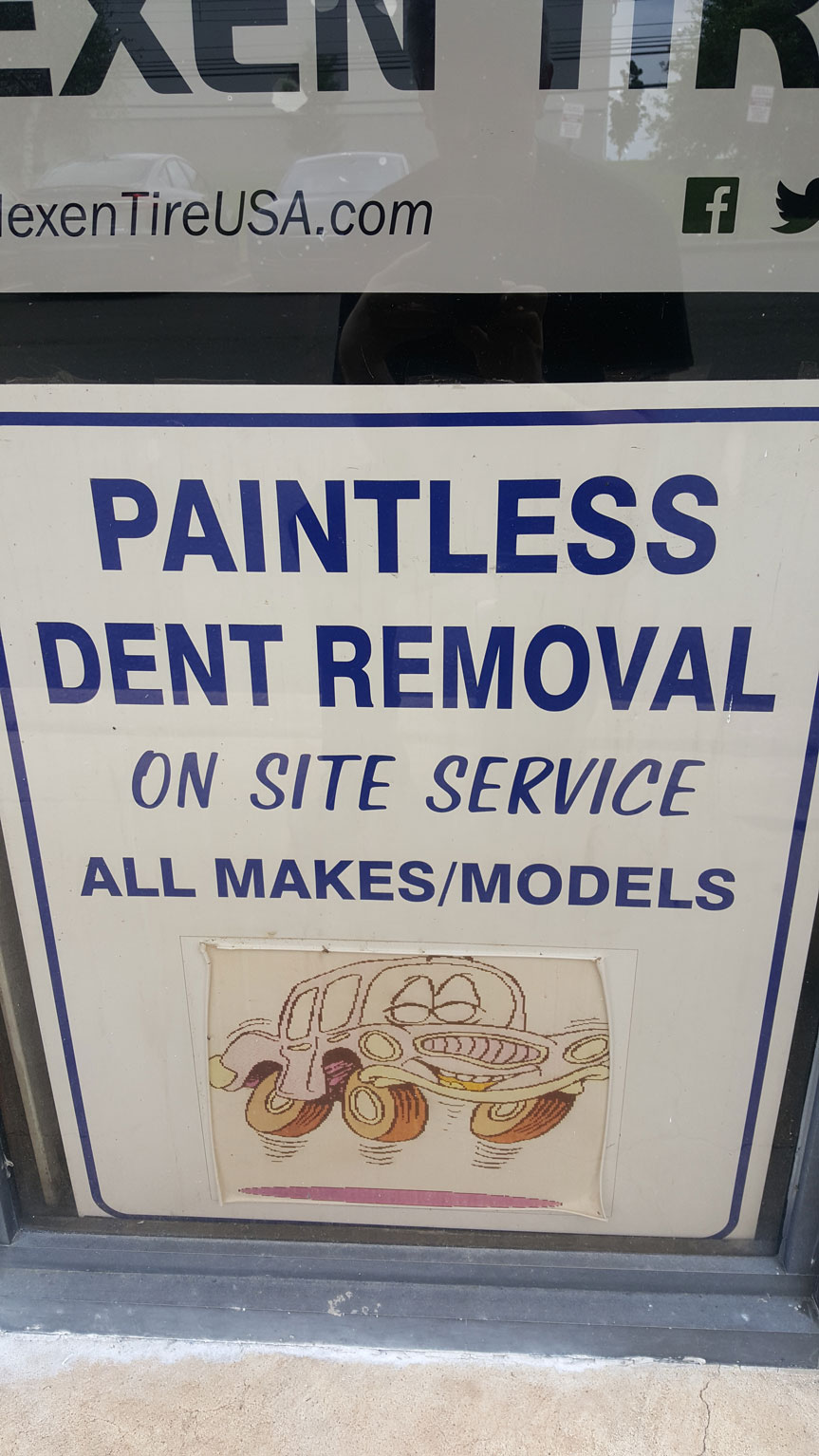 On-site paintless dent removal service sign at AH Motor LLC, specializing in comprehensive auto repair in Hackensack.